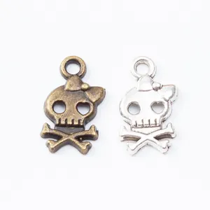 Vintage zinc alloy skull pendants with bow decoration in bronze and silver finishes