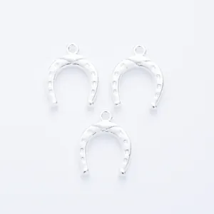 Three horseshoe pendants in vintage zinc alloy featuring detailed nail hole textures