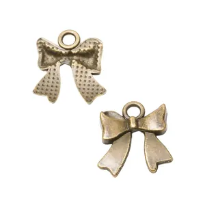Pair of vintage bronze bow alloy pendants with textured back for DIY jewelry making