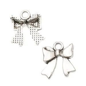 Vintage silver bow-knot metal pendants for DIY jewelry making with front and back view