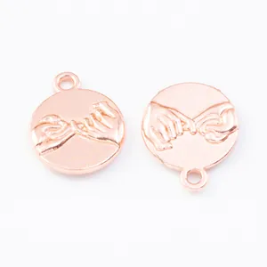 Macro view of rose gold round charms with relief pinky promise gesture and closed rings
