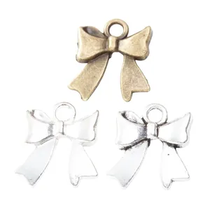 Vintage zinc alloy bow pendants in antique bronze and silver finishes for DIY jewelry making