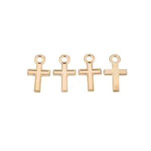 Macro detail of four gold cross alloy pendants with polished finish for DIY jewelry making