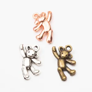 Detail of vintage teddy bear charms in rose gold, silver, and bronze finish