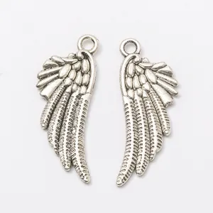 Pair of vintage silver alloy wing charms with detailed feather texture and top hanging loops