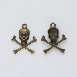 Macro view of vintage bronze skull and crossbones pendants for DIY jewelry making