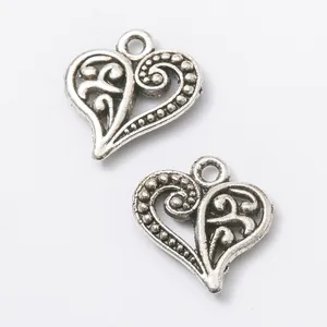 Pair of vintage silver heart charms with intricate filigree patterns for DIY jewelry making