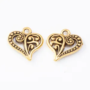 Macro view of vintage heart charms with hollow patterns for DIY jewelry making