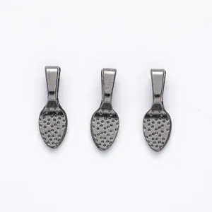 Detailed view of gunmetal alloy jewelry pendant connectors with textured dot finish