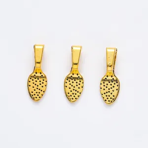 Close-up of golden leaf-shaped pendant bails with textured detail for DIY jewelry making