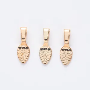 Detailed macro view of three golden leaf-textured alloy pendant bails for jewelry DIY