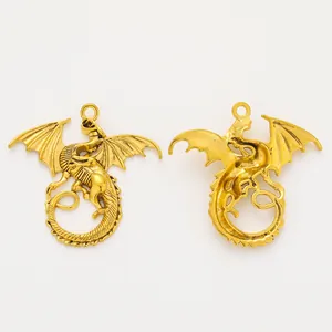 Pair of vintage zinc alloy dragon pendants in gold finish showing front and back views