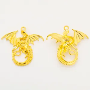 Detailed view of two golden flying dragon pendants for DIY jewelry making accessories