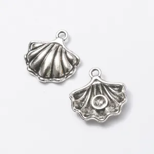 Detailed close-up of shell-shaped silver alloy charms with grooved texture for DIY jewelry