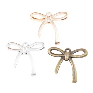 Three-color vintage alloy bow pendants in silver, gold, and bronze for DIY jewelry making