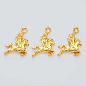 Detailed macro view of three vintage matte gold Pegasus charms for DIY jewelry making