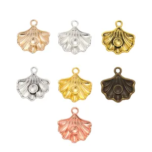 Set of seven vintage shell-shaped alloy pendants in various metallic finishes and colors