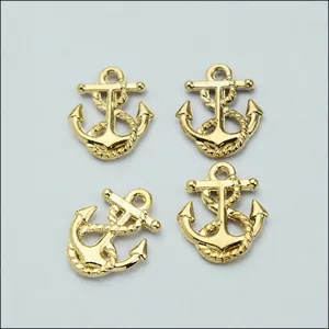 Detailed close-up of four vintage gold alloy ship anchor pendants for DIY jewelry