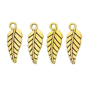 Detailed view of four vintage golden leaf charms with intricate veins for DIY jewelry making