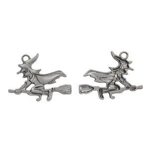Front and back detail of antique silver witch on broomstick Halloween metal pendant