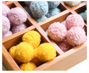 Detail of colorful handmade wool felt balls for DIY hair clips and accessories