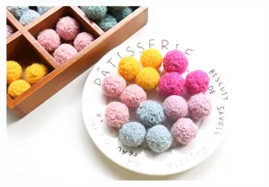 Macro view of colorful wool felt balls in assorted pastel tones for DIY crafts