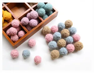 Macro detail of assorted colorful wool felt balls for DIY crafts and accessories