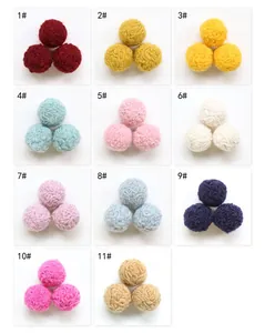 Detailed palette of large wool felt balls in 11 colors for DIY craft and accessories