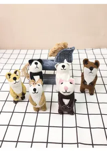 Detailed view of handmade needle felted wool animal figurines on a checkered tablecloth