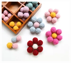 Macro detail of multicolored wool felt balls arranged in a flower for DIY crafts