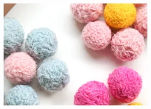 Macro detail of colorful spiral wool felt balls for DIY hair accessories and earrings