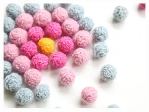 Macro detail of colorful handmade wool felt balls for DIY earring and bag accessories