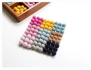 Colorful handmade wool felt balls arranged neatly for DIY jewelry and accessory making