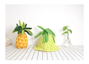 Detail of handmade wool felt pineapple hat with vibrant yellow and green textures