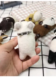 Detail view of the metal pin attachment on the back of a handmade wool felt animal brooch