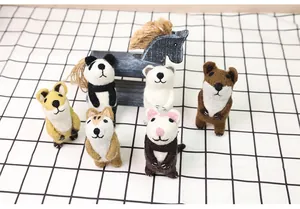 Detailed view of handmade wool felt animal brooches featuring pandas and foxes on grid cloth
