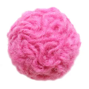 Rose pink wool felt ball craft accessory with soft curly fiber texture on white background