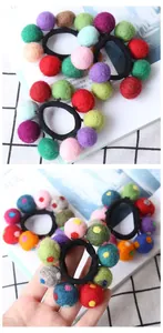 Detailed view of colorful handmade wool felt balls on high-elastic hair bands for women