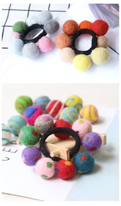 Detail of colorful handmade wool felt balls and elastic hair ties in various patterns