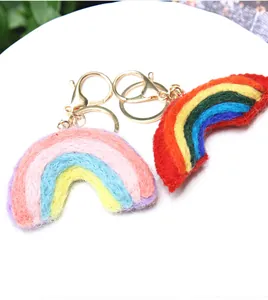 Handmade wool felt rainbow keychains with gold metal clasps in vibrant and macaron tones