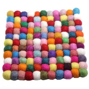 Square multicolored handmade wool felt ball coaster with vibrant soft textured design