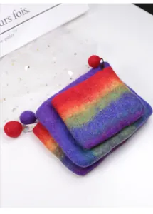 Macro detail of handmade wool felt coin purses with rainbow gradient and zipper