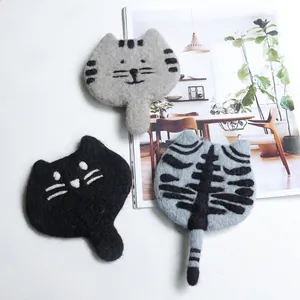 Three cute wool felt cat coasters in black and grey, handmade style home table mats