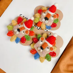 Handmade wool felt lion brooch set with colorful petals and red Christmas hat