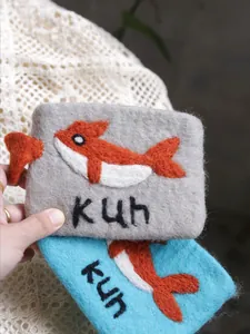 Handmade wool felt coin purse with cute whale pattern and kun text in blue and gray