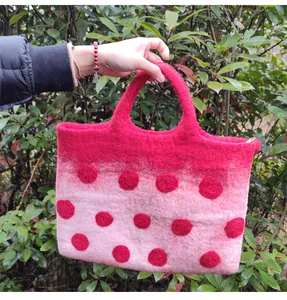Detail of wool felt tote bag showing red gradient design and handle construction