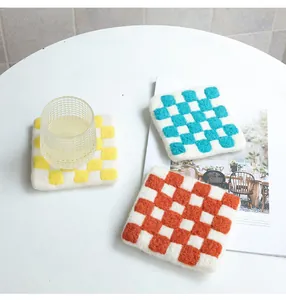 Detailed texture of colorful checkerboard wool felt coasters for heat insulation