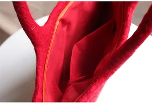 Close-up of red wool felt tote bag interior with zipper closure and inner pocket