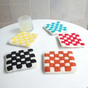 Colorful checkered wool felt coasters set of 5 on a table for heat insulation