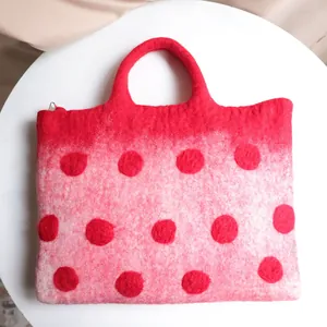 Red wool felt laptop handbag with dark red polka dots and soft fiber texture